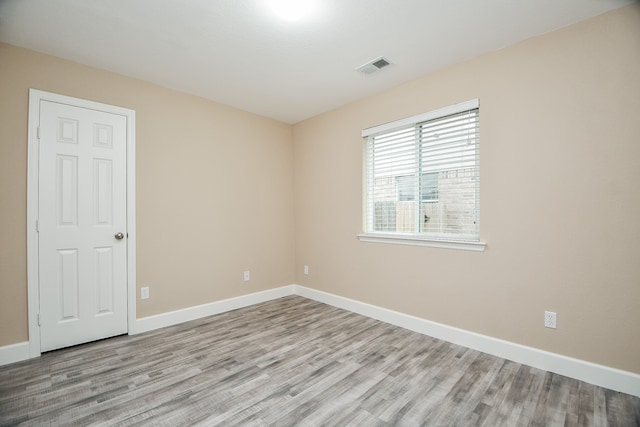 unfurnished room with light wood-type flooring