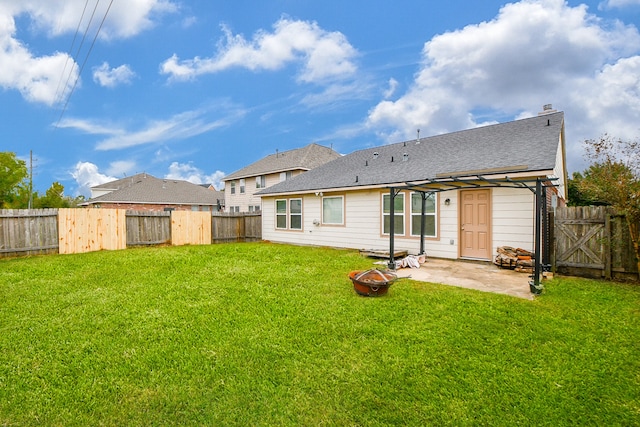 rear view of house with a patio area and a lawn