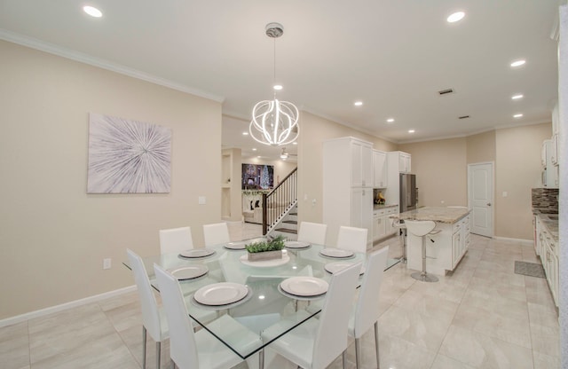 dining room featuring ornamental molding and a notable chandelier