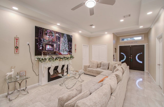 living room with ornamental molding and ceiling fan