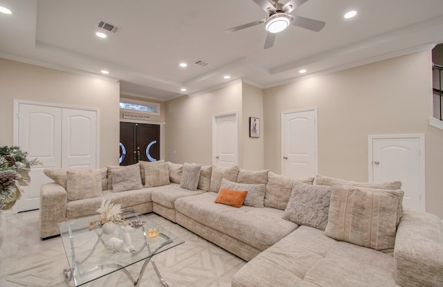 living room featuring ceiling fan and ornamental molding