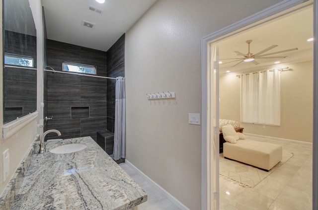 bathroom featuring vanity, curtained shower, and ceiling fan