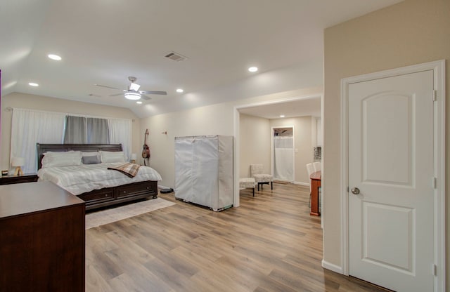 bedroom featuring vaulted ceiling, light hardwood / wood-style flooring, and ceiling fan