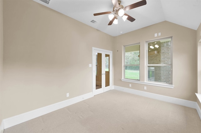 carpeted empty room featuring lofted ceiling, ceiling fan, and french doors