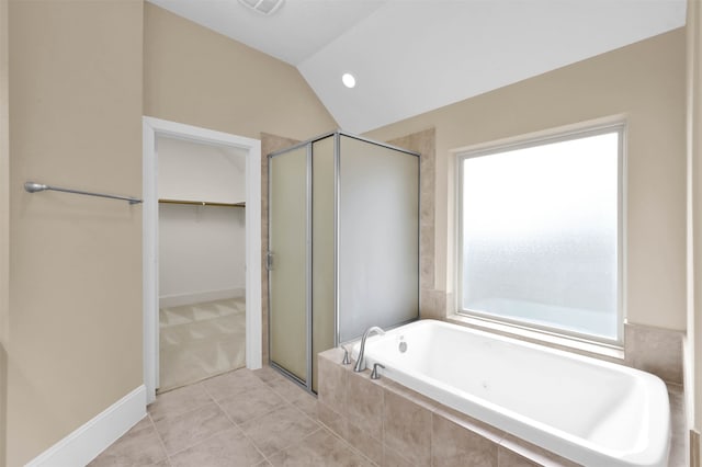 bathroom with independent shower and bath, vaulted ceiling, and tile patterned flooring