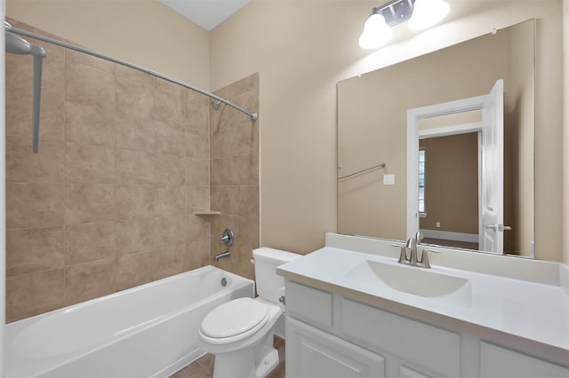 full bathroom with toilet, vanity, tiled shower / bath, and tile patterned floors