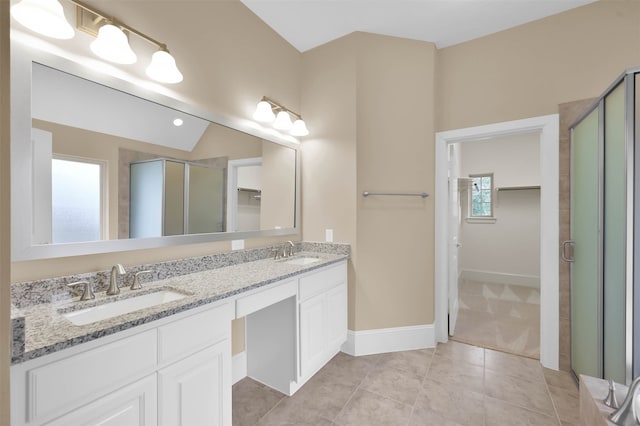 bathroom with plenty of natural light, vanity, tile patterned floors, and a shower with door