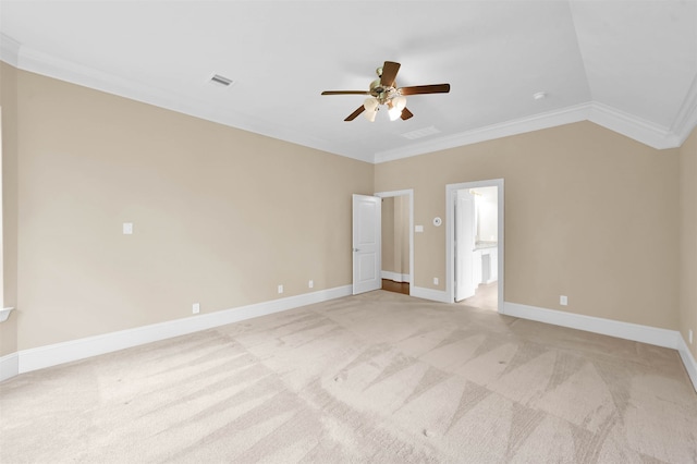 carpeted spare room with ornamental molding, ceiling fan, and vaulted ceiling