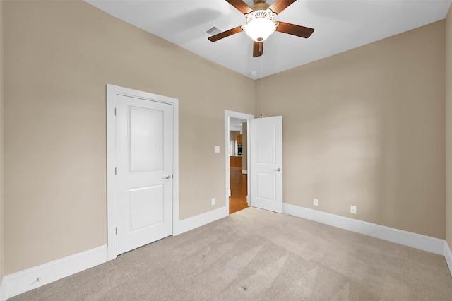 unfurnished bedroom with light colored carpet and ceiling fan