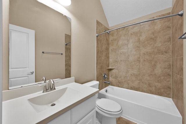 full bathroom with vanity, toilet, vaulted ceiling, and tiled shower / bath combo