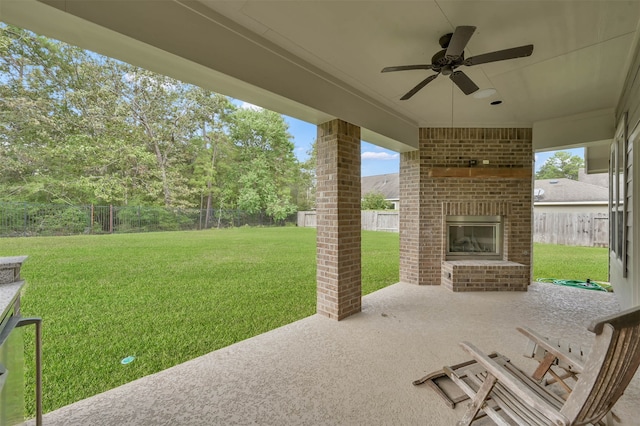 view of patio / terrace featuring an outdoor brick fireplace and ceiling fan