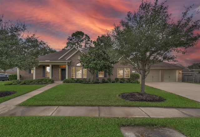 view of front of home featuring a garage and a lawn