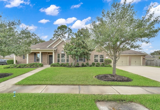 view of front of property with a garage and a front lawn