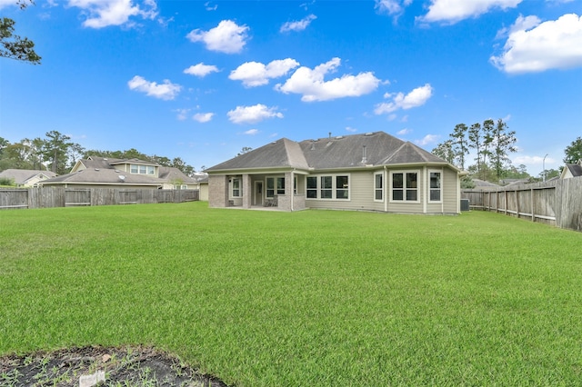 rear view of house with a yard