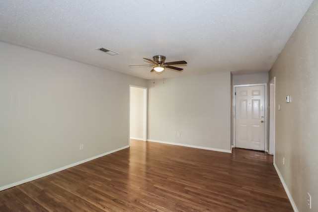 spare room featuring a textured ceiling, dark hardwood / wood-style floors, and ceiling fan