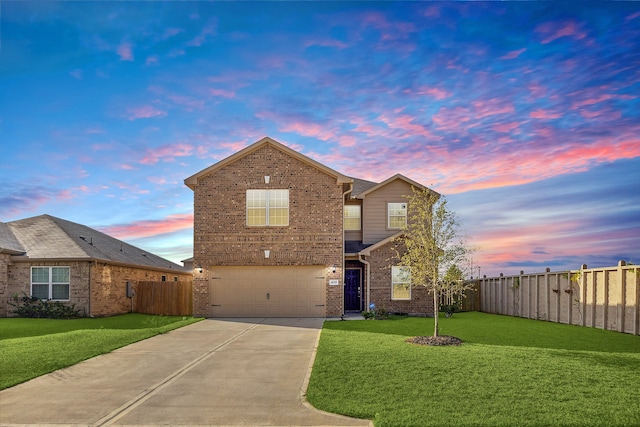 front facade featuring a garage and a lawn