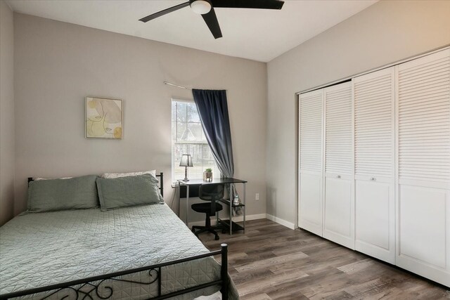 bedroom with hardwood / wood-style flooring, a closet, and ceiling fan