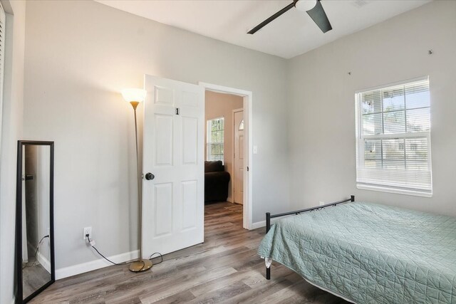 bedroom with light hardwood / wood-style floors and ceiling fan