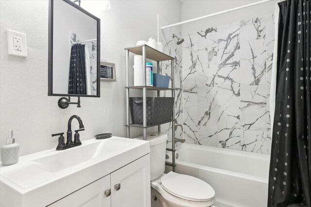 full bathroom with vanity, shower / tub combo, and toilet