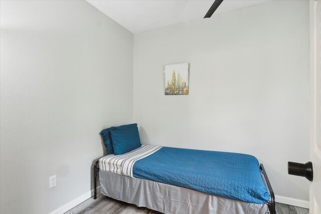 bedroom featuring wood-type flooring and ceiling fan