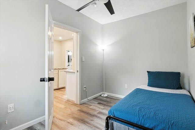 bedroom with light hardwood / wood-style floors and ceiling fan