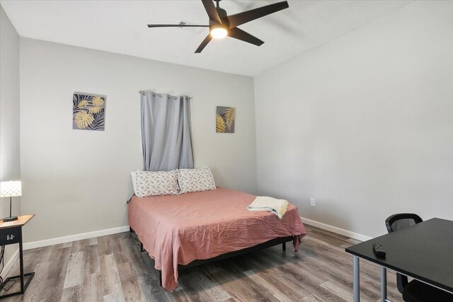 bedroom with ceiling fan and wood-type flooring