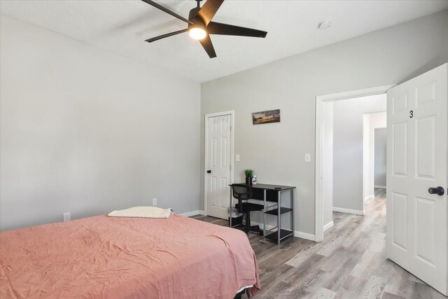 bedroom with light hardwood / wood-style flooring and ceiling fan