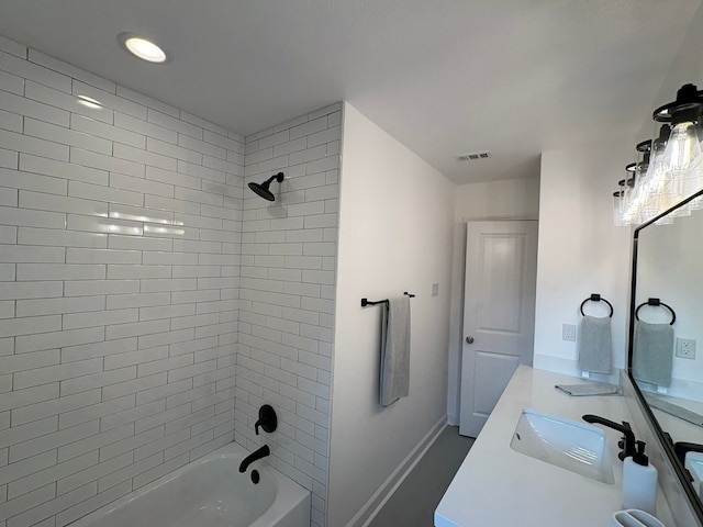 bathroom featuring vanity and tiled shower / bath combo