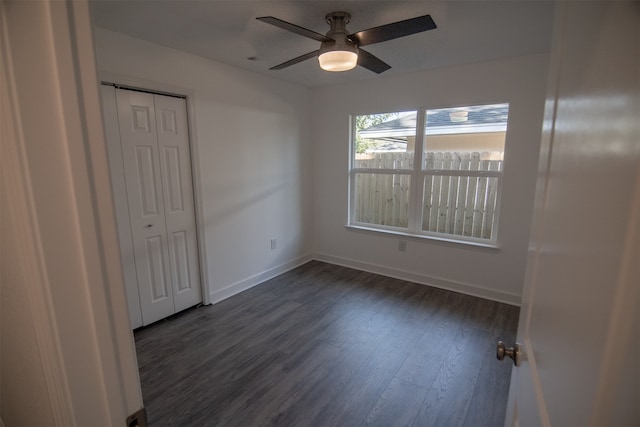 unfurnished room with ceiling fan and dark hardwood / wood-style floors