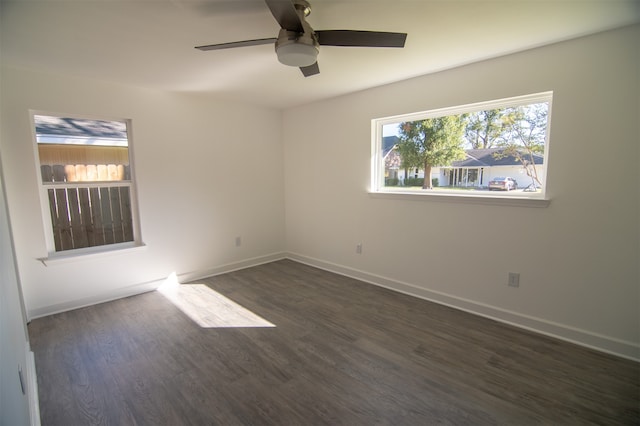 empty room with ceiling fan and dark wood-type flooring