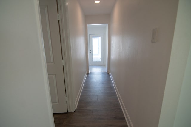 hallway with dark hardwood / wood-style flooring