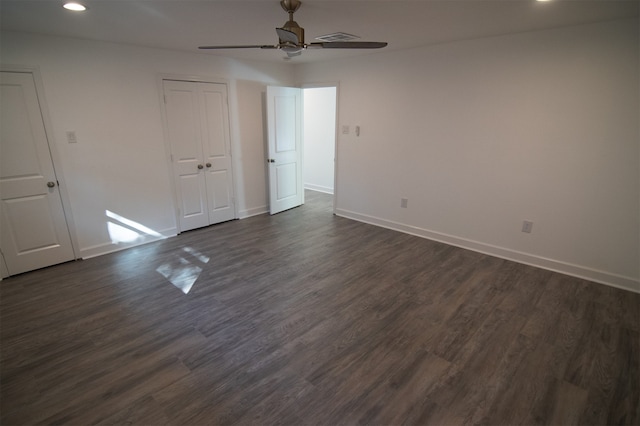 spare room with ceiling fan and dark wood-type flooring