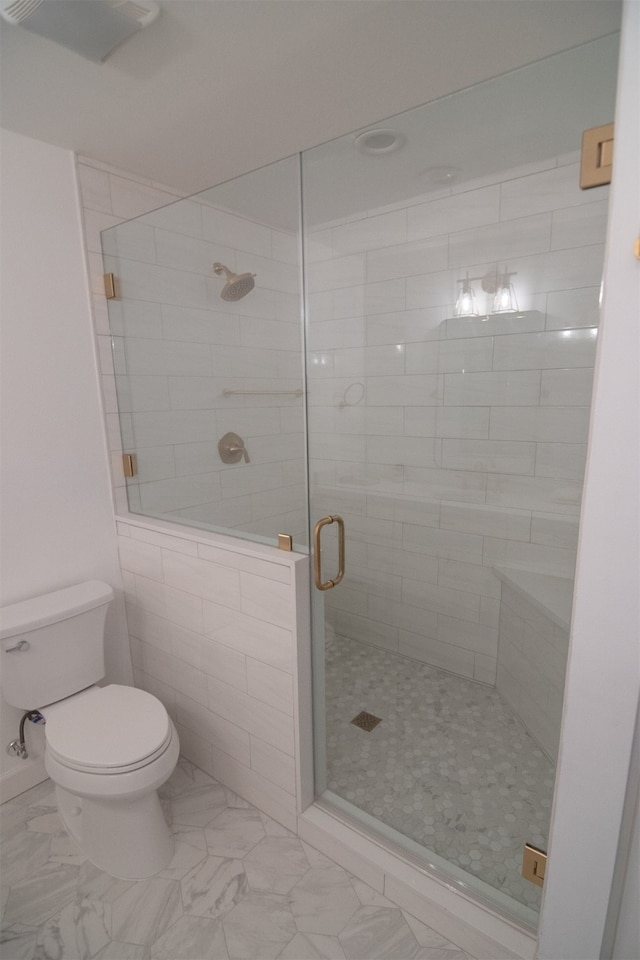 bathroom with toilet and walk in shower