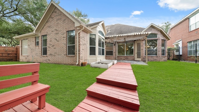 back of property featuring a pergola, a yard, and a deck