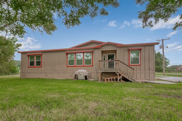 back of property featuring a yard