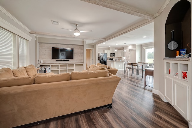 living room with crown molding, beamed ceiling, dark hardwood / wood-style flooring, and ceiling fan