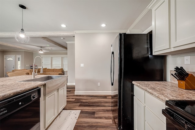 kitchen with dark wood-type flooring, black appliances, and white cabinets