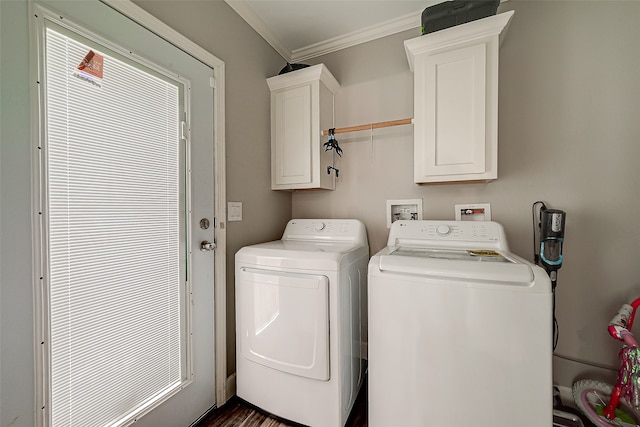 clothes washing area with crown molding, cabinets, and washer and dryer