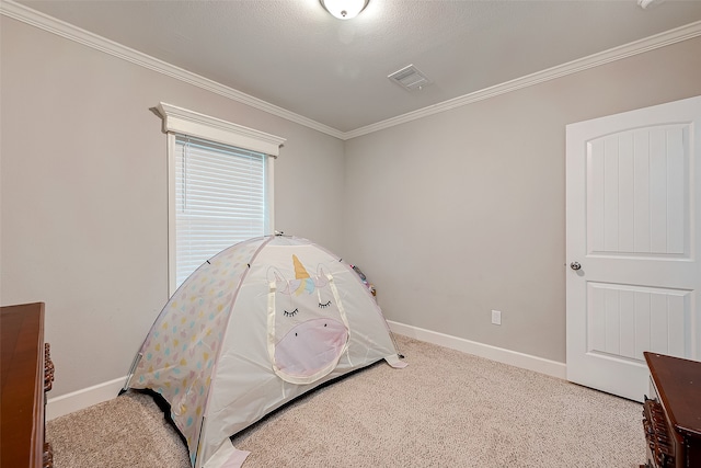 bedroom with crown molding, carpet floors, and a textured ceiling