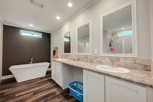 bathroom with tasteful backsplash, shower with separate bathtub, wood-type flooring, ornamental molding, and vanity