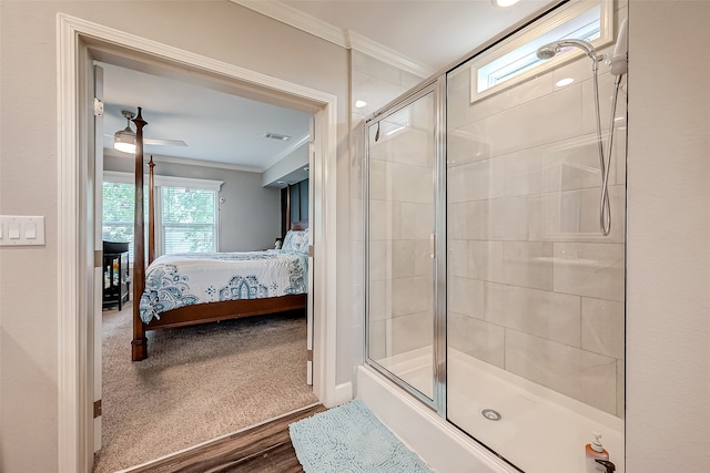 bathroom with a shower with door, crown molding, wood-type flooring, and ceiling fan