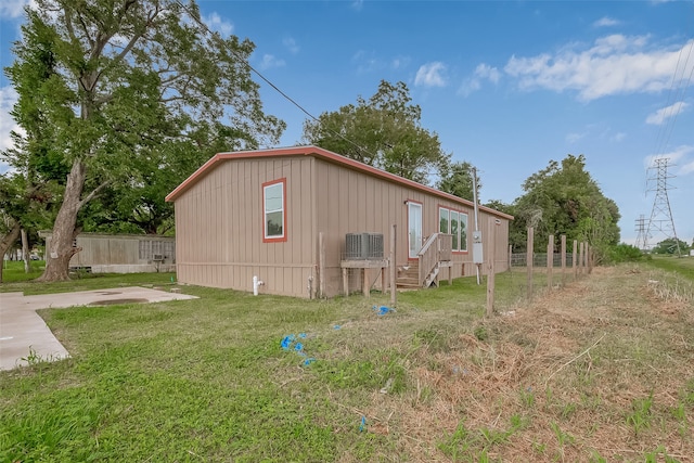 view of side of home featuring a yard