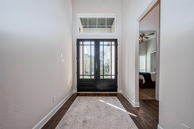 foyer entrance featuring a high ceiling, ceiling fan, french doors, and dark hardwood / wood-style floors