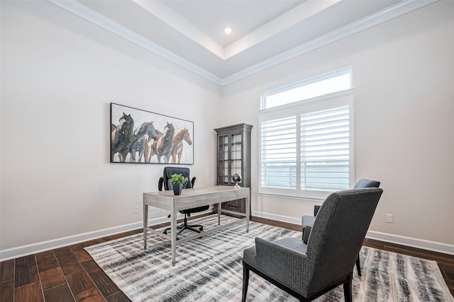 office space featuring ornamental molding, dark wood-type flooring, and a tray ceiling