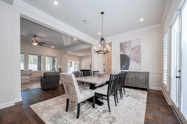 dining space featuring ceiling fan with notable chandelier, dark hardwood / wood-style floors, and crown molding