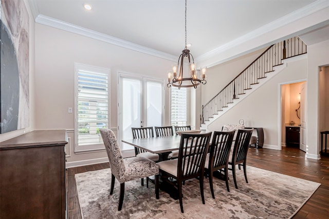 dining space with dark wood-type flooring, a notable chandelier, and ornamental molding