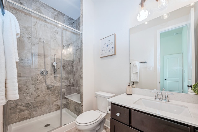 bathroom featuring an enclosed shower, vanity, and toilet