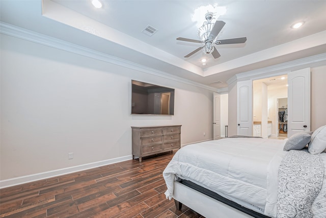 bedroom with ceiling fan, ornamental molding, dark hardwood / wood-style flooring, and a tray ceiling