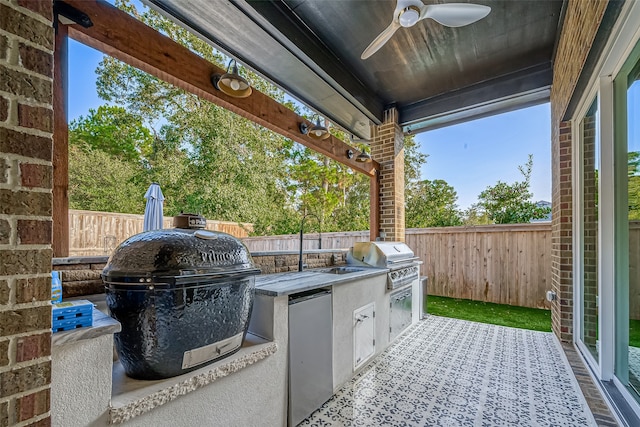 view of patio with area for grilling, ceiling fan, and sink