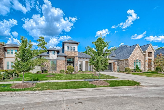 view of front of property with a garage and a front lawn